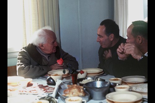 1969 -  DAVID BEN GURION (L) HOSTING MK SHIMON PERES (C) FOR LUNCH IN THE DINING ROOM OF KIBBUTZ SDE BOKER. (GPO)