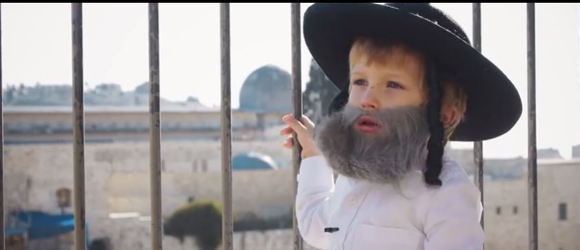 Child playing role of Jewish tour guide in Jerusalem