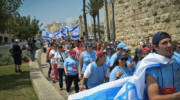 Israeli youth march in Jerusalem with flags