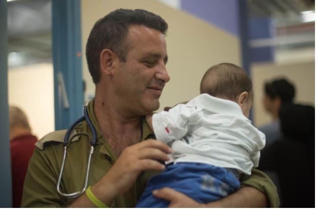 IDF soldier and Syrian child