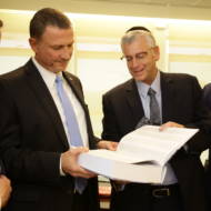 Knesset Speaker Yuli Edelstein and UWi staff display the Jerusalem Declaration