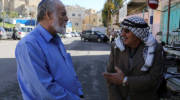 A Palestinian and an Israeli seen talking in Hebron,