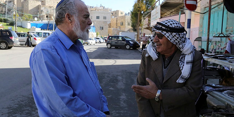 A Palestinian and an Israeli seen talking in Hebron,
