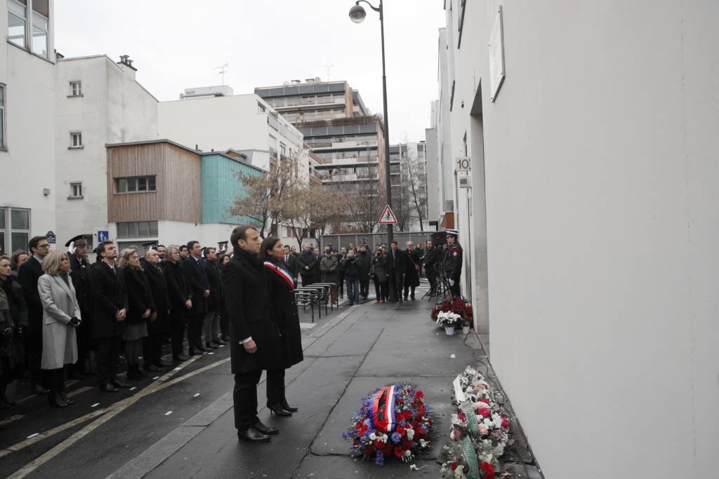 French politicians observe a minute of silence outside Charlie Hebdo's former office. (AP Photo/Christophe Ena, Pool)