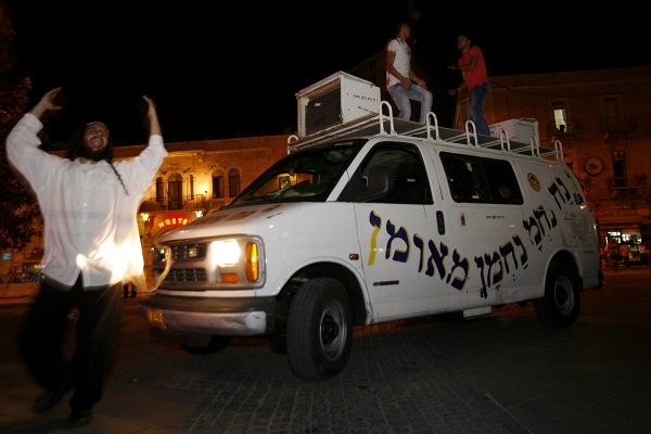 Dancing on a van roof in Jerusalem. (Miriam Alster/Flash90)