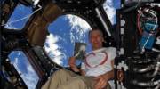 US Astronaut Andrew Feustel and a copy of Petr Ginz's "Moon Landscape" in Space