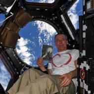 US Astronaut Andrew Feustel and a copy of Petr Ginz's "Moon Landscape" in Space