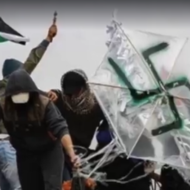 Palestinian rioters in Gaza with a swastika-adorned arson. (screenshot)