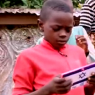 A Nigerian boy uses the tablet he was given through an Israeli program