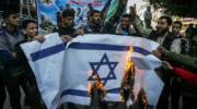 Palestinians burn an Israeli flag