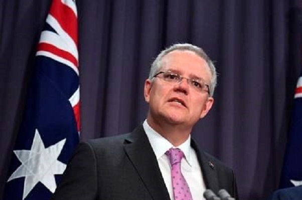 Prime Minister Scott Morrison, left, speaks to the media alongside Minister for Foreign Affairs Marise Payne during a press conference at the Parliament House in Canberra, Tuesday, October 16, 2018. Morrison said Tuesday that he was open to shifting the Australian Embassy from Tel Aviv to Jerusalem in line with President Donald Trump's decision to recognize the contested holy city as Israel's capital. (Mick Tsikas/AAP Image via AP)