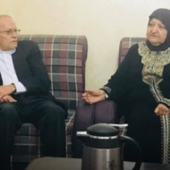 Palestinian Prisoners’ Affairs Director Qadri Abu Bakr (L) with the mother of multiple terrorists Um Yusuf Abu Hmeid. (PMW)