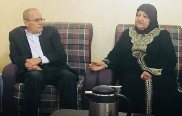 Palestinian Prisoners’ Affairs Director Qadri Abu Bakr (L) with the mother of multiple terrorists Um Yusuf Abu Hmeid. (PMW)