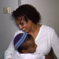 Miri Tamano with one of her children. (screenshot)