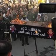 Palestinians torch photos of Netanyahu and Trump. (Facebook)