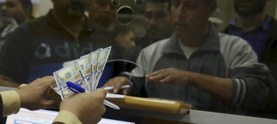 An employee of the Hamas terror group receives a salary payment  financed by millions of dollars in aid from Qatar. (AP Photo/Adel Hana)
