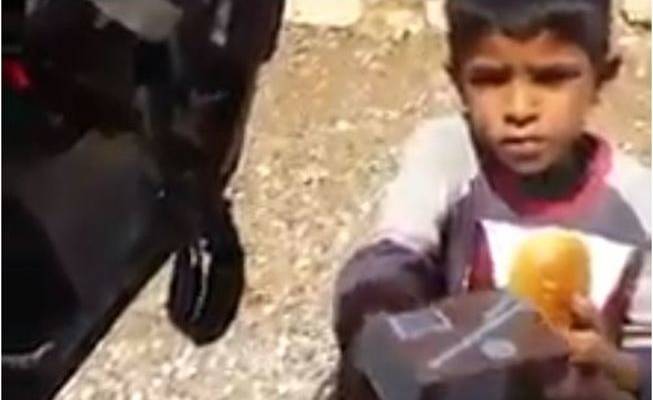 Palestinian child gets lunch from IDF soldier