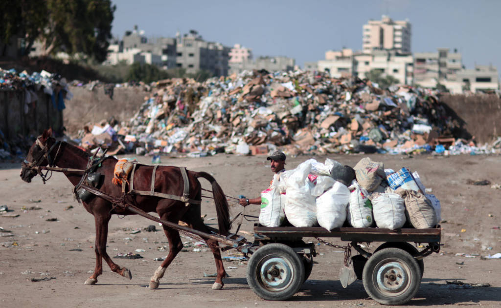 A Palestinian at a dump in Gaza City. (Wissam Nassar/Flash90)