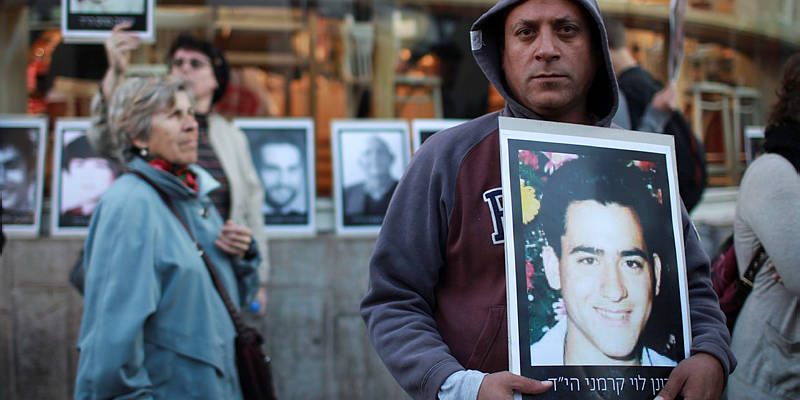 Israeli protesters display photos of victims of Palestinian terror.