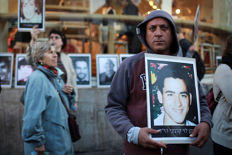 Israeli protesters display photos of victims of Palestinian terror.