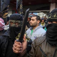 Palestinians glorify terror in an anti-Israel rally. (Abed Rahim Khatib/Flash90)