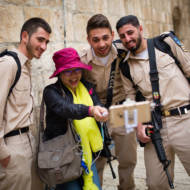 A tourist seen taking selfies with soldiers in Jerusalem's Old City. (Corinna Kern/FLASH90)