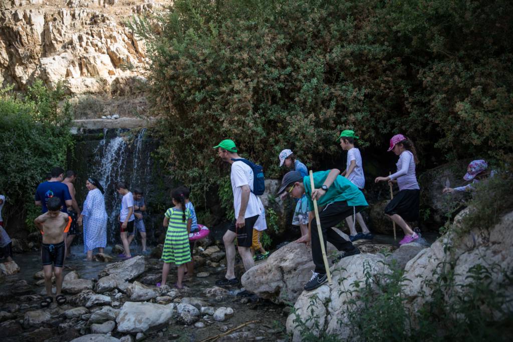 Hikers at Israel's Ein Meboa Spring. (Hadas Parush/Flash90)