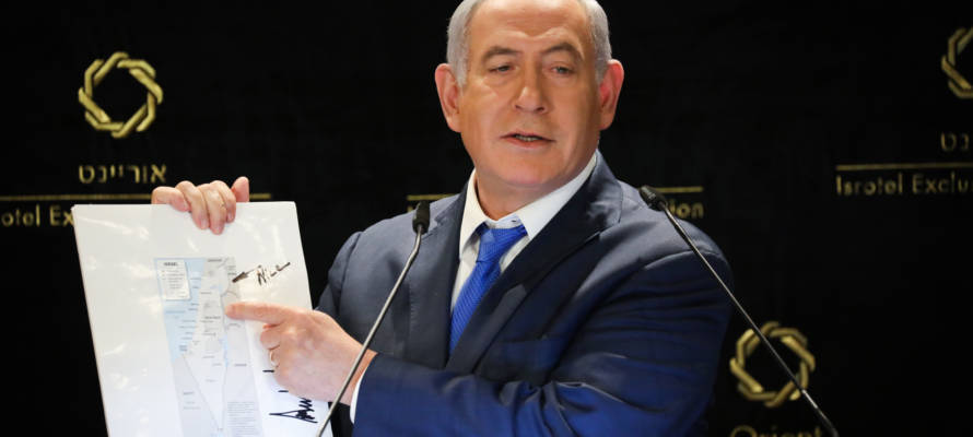 Israeli PM Benjamin Netanyahu with a map from President Donald Trump. (Noam Revkin Fenton/Flash90)