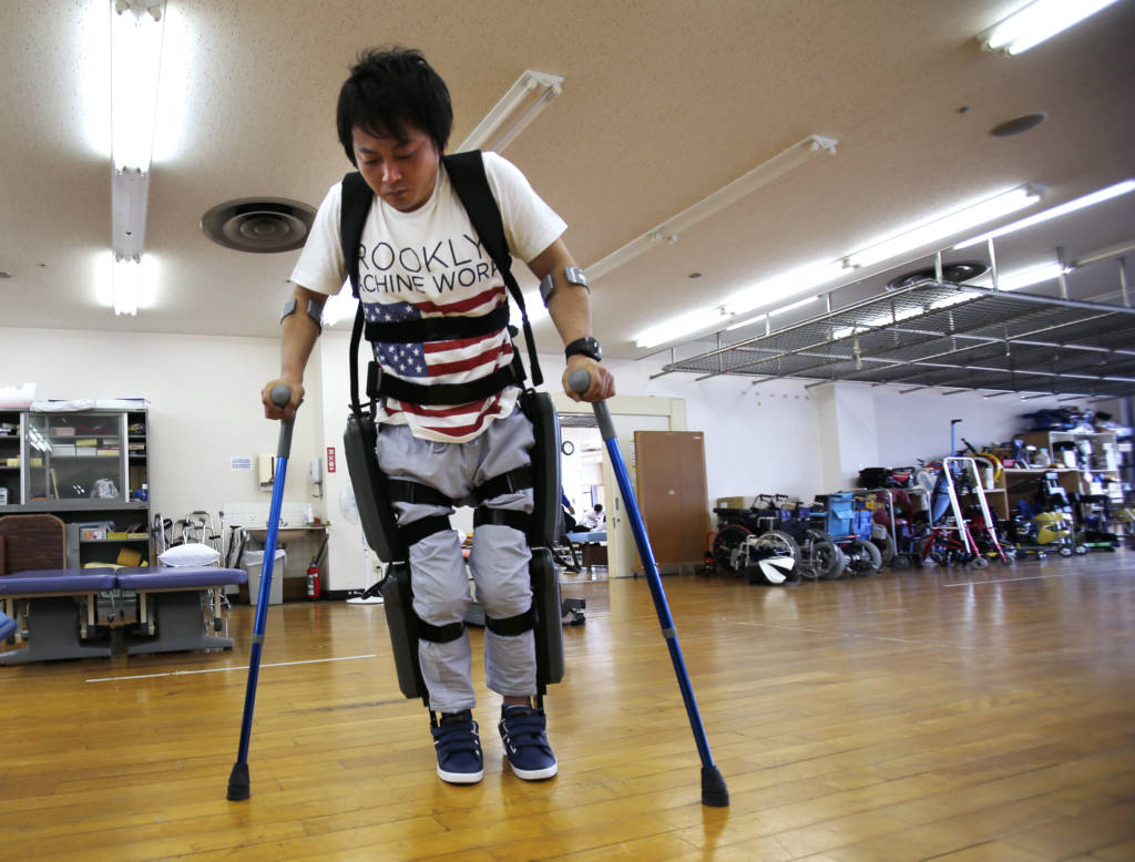 Yuichi Imahata walks using a robotic exoskeleton called ReWalk in Tokyo. (AP Photo/Shuji Kajiyama)