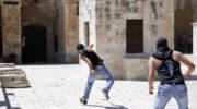 Palestinians throw stones at Israelis on the Temple Mount in a previous clash. (illustrative) (Sliman Khader/Flash 90)