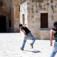 Palestinians throw stones at Israelis on the Temple Mount in a previous clash. (illustrative) (Sliman Khader/Flash 90)