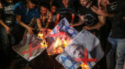 Palestinians in Gaza burn pictures