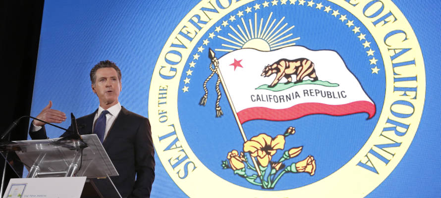 California Gov. Gavin Newsom speaks in front of the state seal, Thursday, May 23, 2019, in Sacramento, Calif.