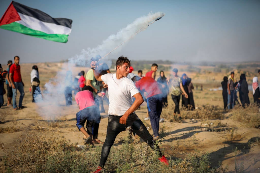 Palestinian protesters clash with Israeli forces at the Israel-Gaza border, July 26, 2019.