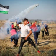 Palestinian protesters clash with Israeli forces at the Israel-Gaza border, July 26, 2019.