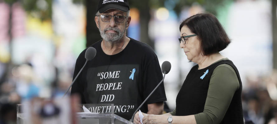 Nic Haros, left, participates in the ceremony marking the 18th anniversary of the attacks of Sept. 11, 2001 at the National September 11 Memorial, Wednesday, Sept. 11, 2019 in New York