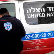 An Orthodox Jewish volunteer of the Emergency Medical Service organization, United Hatzalah, seen near an ambulance in Jerusalem.