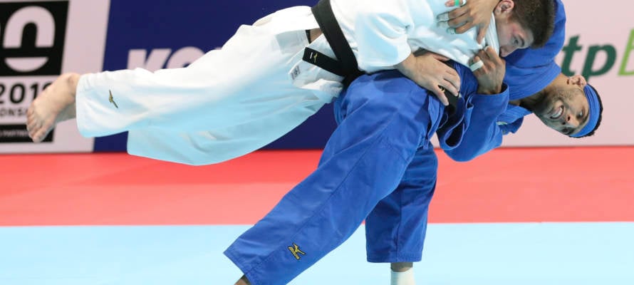 Luka Maisuradze of Georgia, top, competes against Saeid Mollaei of Iran during a men's -81 kilogram bronze medal match of the World Judo Championships in Tokyo, Wednesday, Aug. 28, 2019.