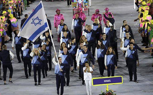 Neta Rivkin carries the flag for the Israeli delegation during the opening ceremony for the 2016 Summer Olympics in Rio de Janeiro, Brazil, Friday, Aug. 5, 2016