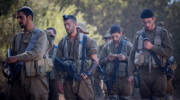 Religious IDF soldiers pray during training.