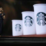 Michelle Burns, Starbucks senior vice president for coffee and tea, stands next to an image of Starbucks cups as she speaks Wednesday, March 20, 2019, during the company's annual shareholders meeting in Seattle.