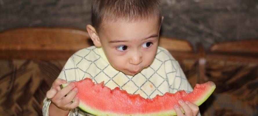 little boy eating watermelon