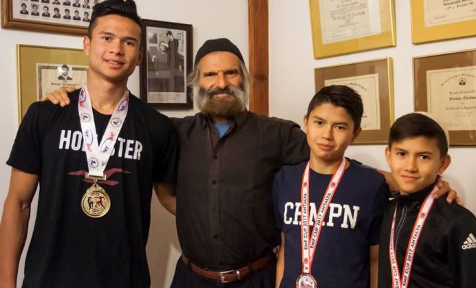 Brothers Kibedy, Ruach Hashem and Ahavat Hashem Gordon with their father, Azriel. (Courtesy)