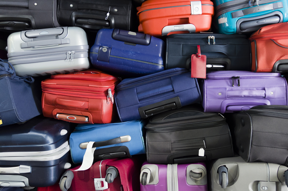 Piled airport luggage (Shutterstock)