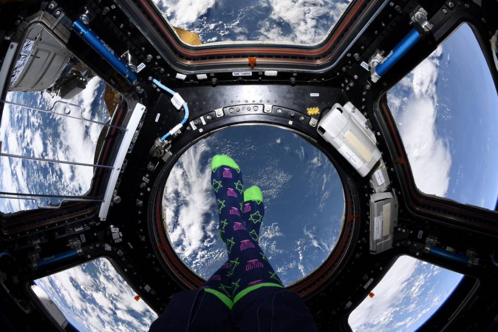 Chanukah socks on the feet of astronaut Jessica Meir, in outer space