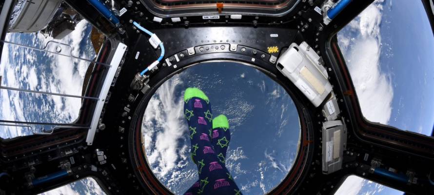 Chanukah socks on the feet of astronaut Jessica Meir, in outer space