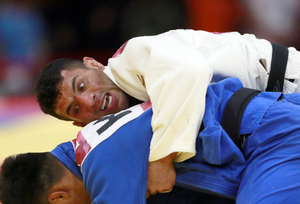 In this Thursday, Aug. 30, 2018 file photo, Saeid Mollaei of Iran, top, competes against Didar Khamza of Kazakhstan during their men's - 81kg final judo match at the18th Asian Games in Jakarta, Indonesia.