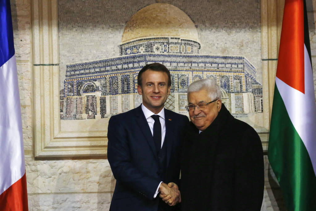 Palestinian leader Mahmoud Abbas, right, welcomes French President Emmanuel Macron