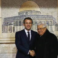 Palestinian leader Mahmoud Abbas, right, welcomes French President Emmanuel Macron