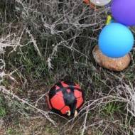 Explosive soccer ball attached to balloons